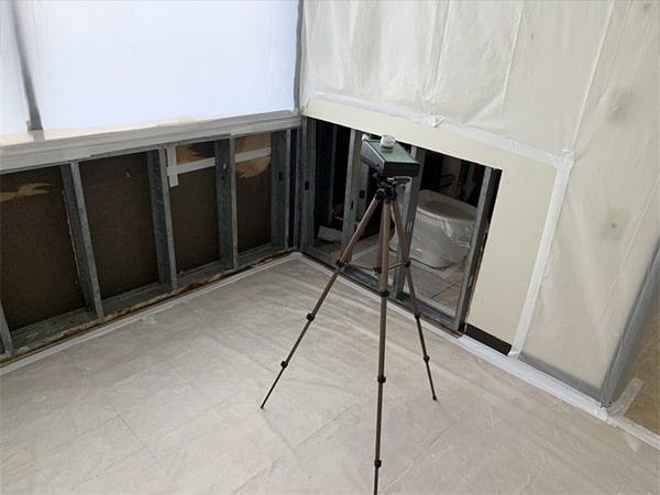 Mold detection equipment in a room next to a bathroom in a mold remediation project overseen by Precision Environmental Services.